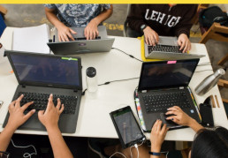 Students on computer in group